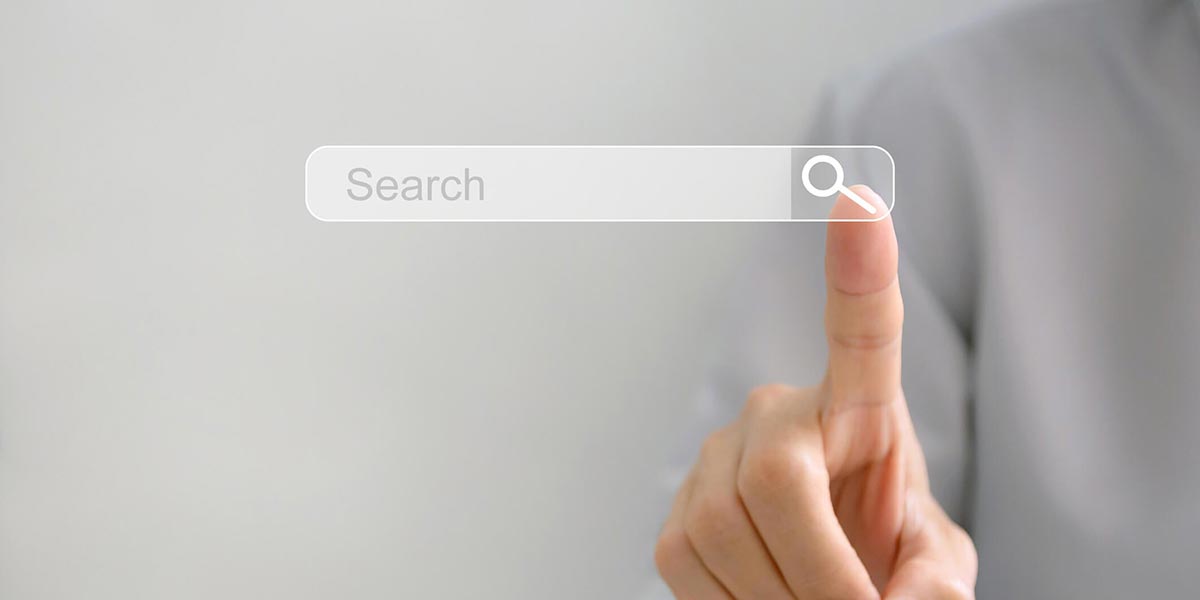 finger touching transparent "search" screen