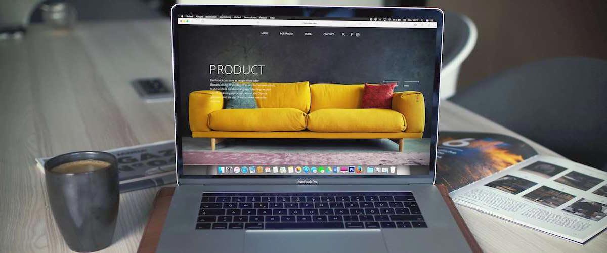 Macbook with product description of couch pulled up